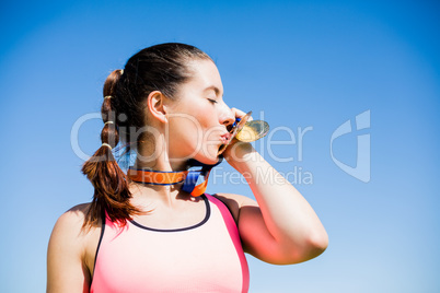 Female athlete kissing her gold medals