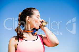 Female athlete kissing her gold medals