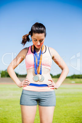 Female athlete with gold medals around her neck