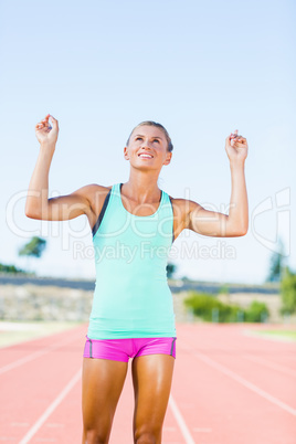 Happy female athlete posing after a victory