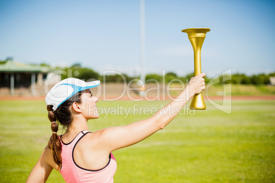 Female athlete holding a fire torch