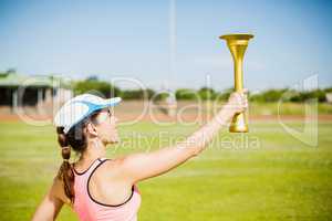 Female athlete holding a fire torch