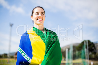 Female athlete wrapped in Brazilian flag