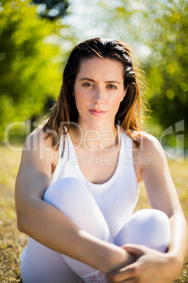 Portrait of beautiful woman sitting on grass