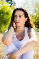 Portrait of beautiful woman sitting on grass