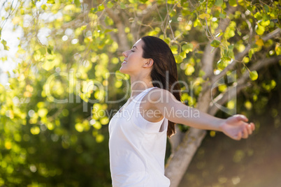 Beautiful woman standing with arms outstretched