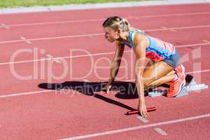 Female athlete ready to start the relay race