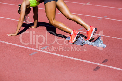 Female athlete ready to run on running track