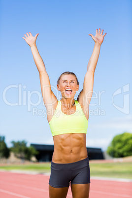 Excited female athlete posing after a victory