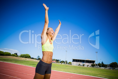 Excited female athlete posing after a victory