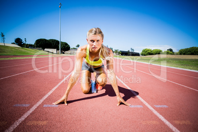 Female athlete ready to run on running track