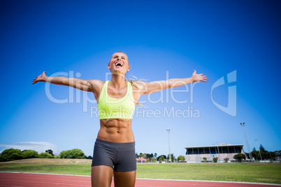 Excited female athlete posing after a victory