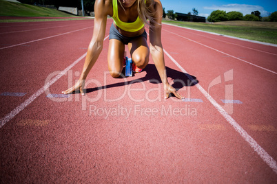 Female athlete ready to run on running track