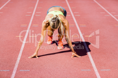 Female athlete ready to run on running track