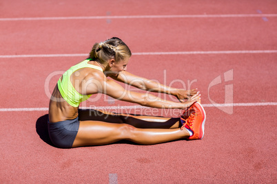 Female athlete warming up on the running track