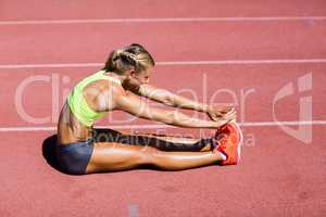 Female athlete warming up on the running track
