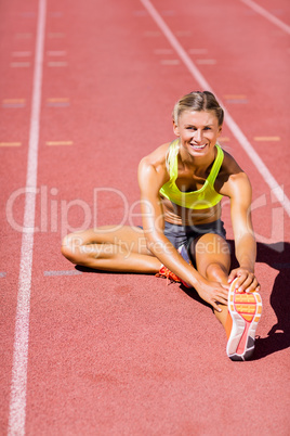 Female athlete warming up on the running track