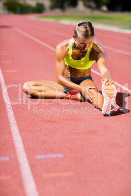 Female athlete warming up on the running track