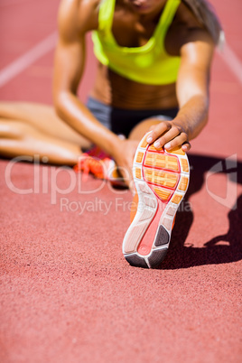 Female athlete warming up on the running track