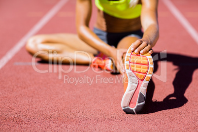 Female athlete warming up on the running track