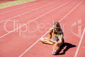 Female athlete warming up on the running track