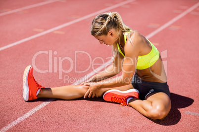 Female athlete warming up on the running track