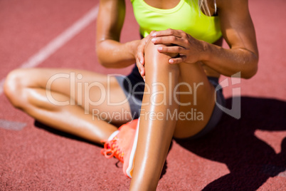 Female athlete warming up on the running track