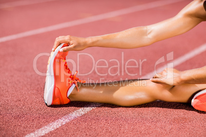 Female athlete warming up on the running track