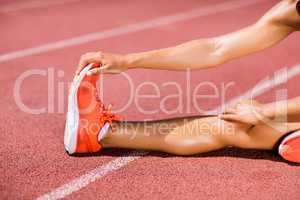 Female athlete warming up on the running track