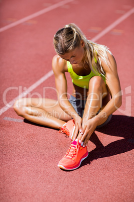 Female athlete warming up on the running track