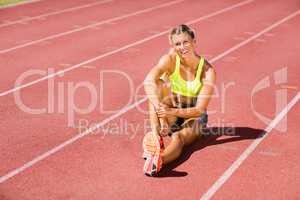 Female athlete sitting on the running track