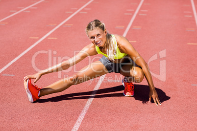 Female athlete warming up on the running track