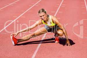 Female athlete warming up on the running track