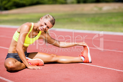 Female athlete warming up on the running track