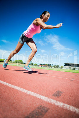 Female athlete running on the running track