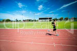 Female athlete running on the running track