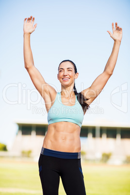 Happy female athlete posing after a victory