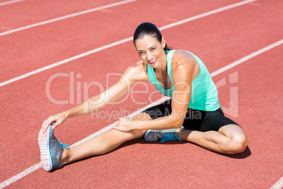 Portrait of female athlete stretching her hamstring