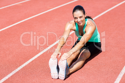 Portrait of female athlete doing stretching exercise