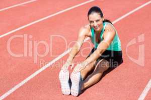 Portrait of female athlete doing stretching exercise