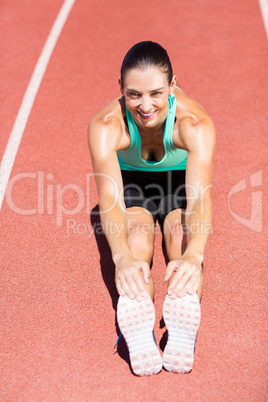 Portrait of female athlete doing stretching exercise