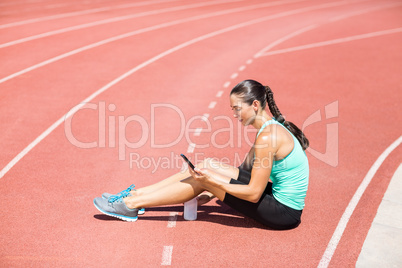 Female athlete using mobile phone