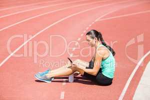 Female athlete using mobile phone