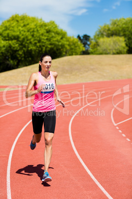 Female athlete running on the running track