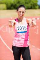 Portrait of female athlete showing her thumbs up