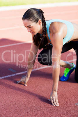 Female athlete in ready to run position