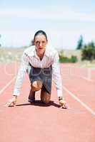 Businesswoman in ready to run position