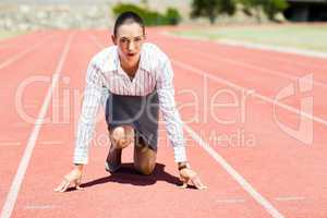 Businesswoman in ready to run position