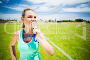 Female athlete kissing his gold medal