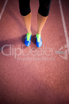 Female athlete feet standing on the running track
